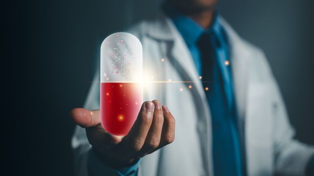 Doctor holding a glowing capsule symbolizing AI-driven drug discovery and molecular innovation 