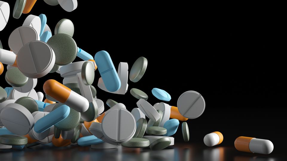 Colorful pills against a black background, representing drugs that influence DNA repair mechanisms.
