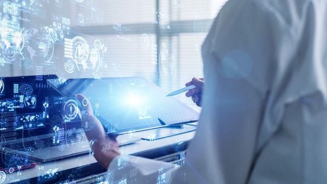 Scientist reviewing digital analytical datasets via holographic interfaces, symbolizing next-generation forensic LIMS technology. 